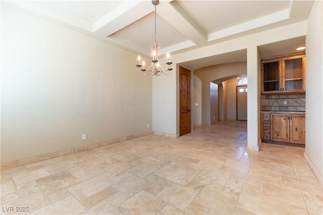 unfurnished dining area featuring a chandelier