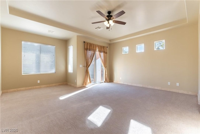 spare room featuring light colored carpet and ceiling fan