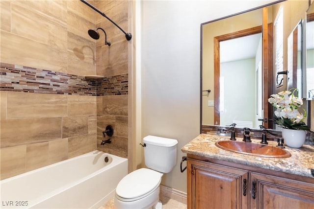 full bathroom with toilet, vanity, and tiled shower / bath