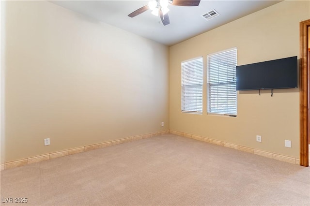 spare room featuring ceiling fan and light colored carpet