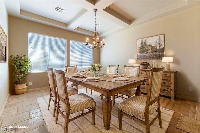 dining room featuring beam ceiling, a notable chandelier, light hardwood / wood-style flooring, and coffered ceiling