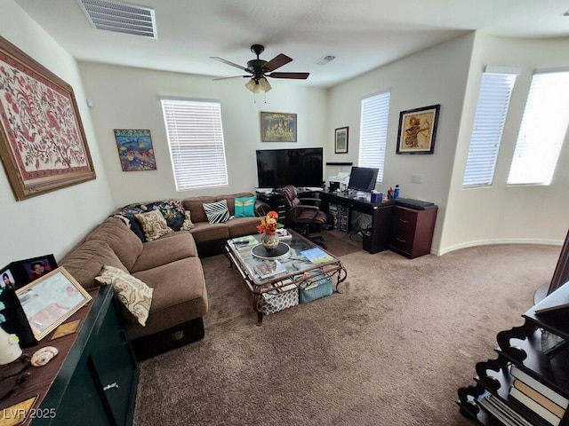 carpeted living room with ceiling fan and plenty of natural light