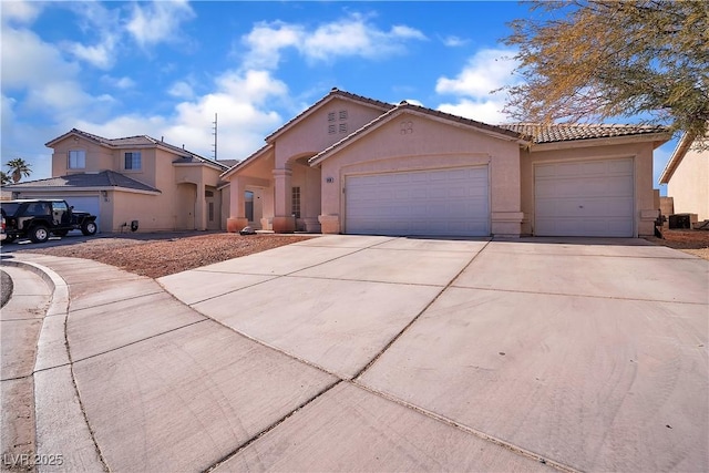 view of front of property with central AC and a garage