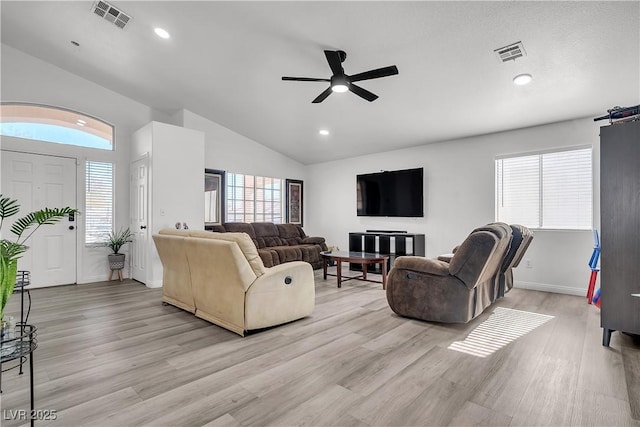 living room with ceiling fan, high vaulted ceiling, and light hardwood / wood-style floors