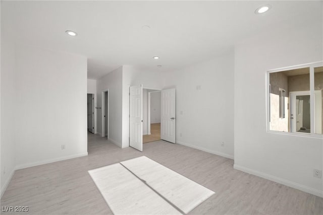 spare room featuring light hardwood / wood-style floors