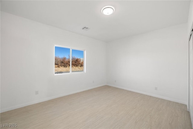 spare room with light wood-type flooring