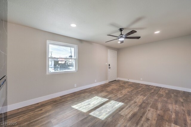 unfurnished room featuring ceiling fan and dark hardwood / wood-style flooring