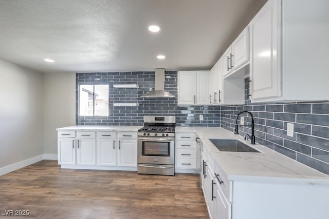 kitchen featuring sink, white cabinetry, wall chimney exhaust hood, stainless steel gas stove, and dark hardwood / wood-style floors