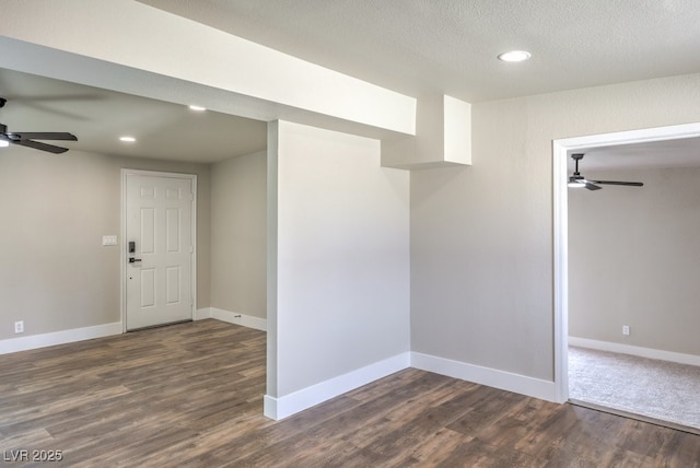 interior space featuring dark wood-type flooring, a textured ceiling, and ceiling fan