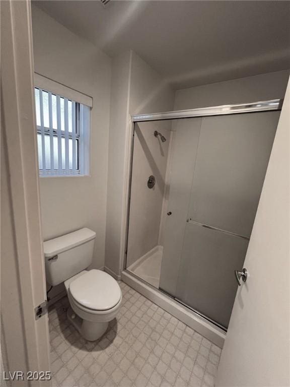 bathroom with toilet and walk in shower