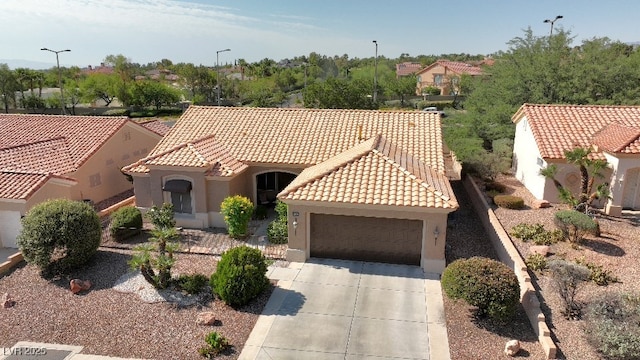 mediterranean / spanish-style house with a garage