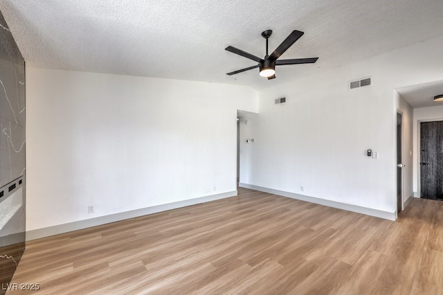 unfurnished room featuring a textured ceiling, ceiling fan, and light hardwood / wood-style floors