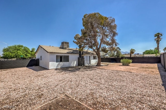 rear view of property featuring a patio and central air condition unit