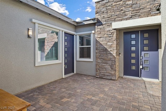 doorway to property with a patio area