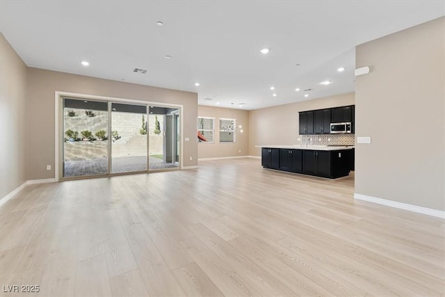 unfurnished living room featuring light hardwood / wood-style flooring