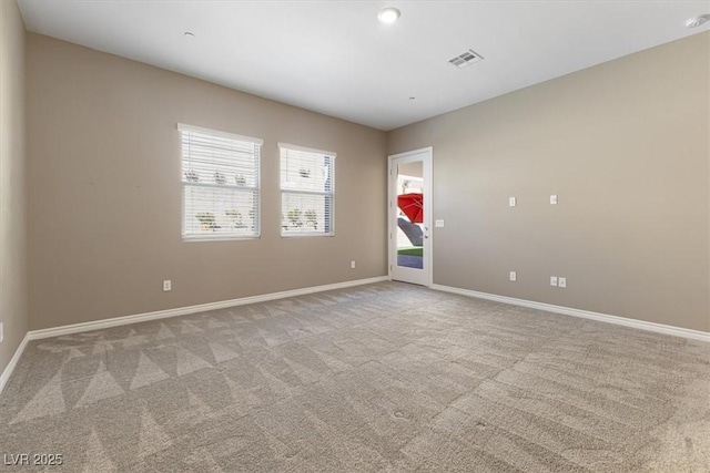 unfurnished room with light carpet