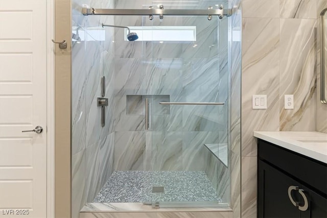 bathroom featuring vanity and a shower with door