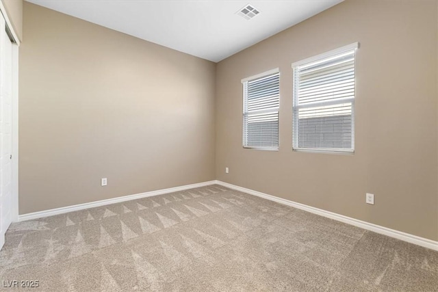 empty room featuring light colored carpet