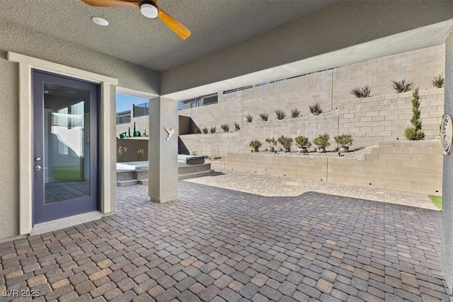 view of patio featuring ceiling fan