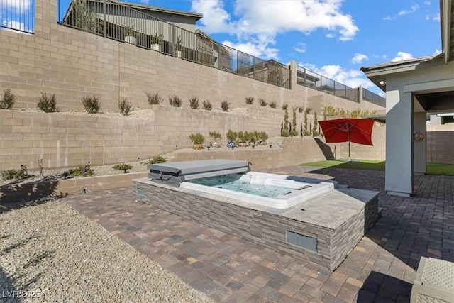 view of patio / terrace featuring a covered hot tub