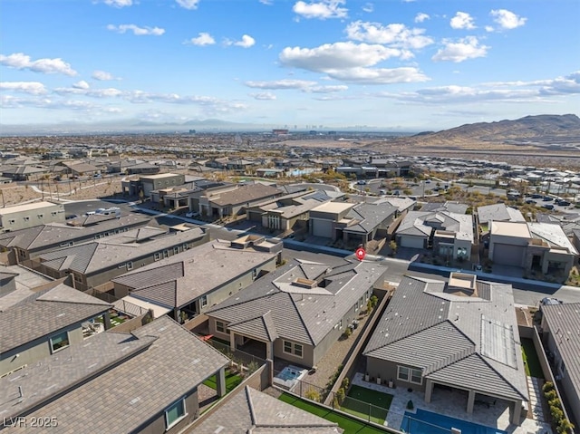 birds eye view of property with a mountain view