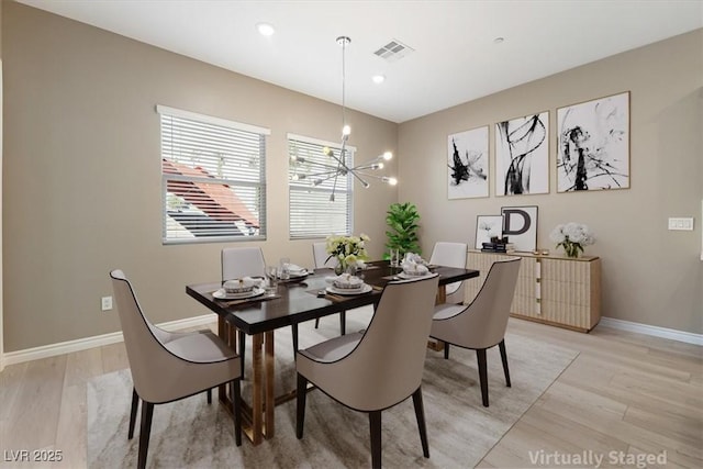 dining room featuring an inviting chandelier and light wood-type flooring