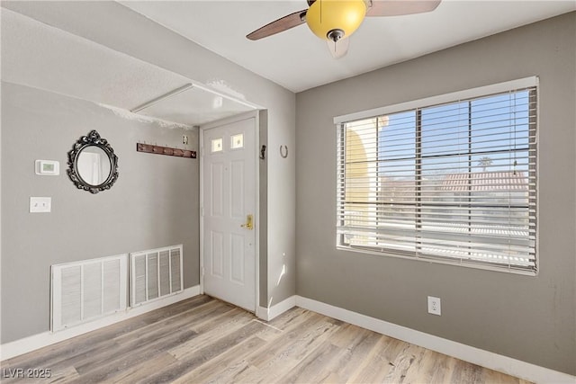 entrance foyer with ceiling fan and light hardwood / wood-style flooring