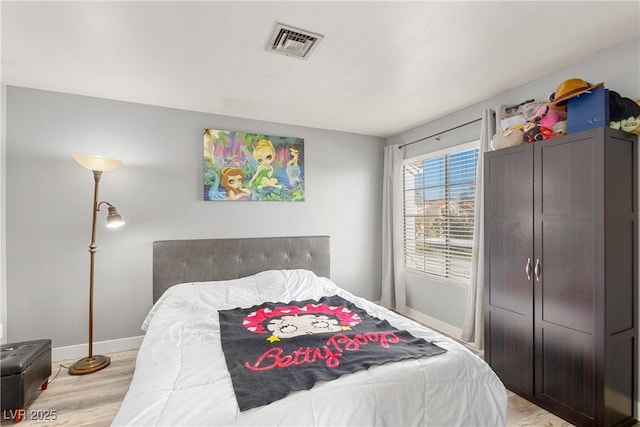 bedroom with light hardwood / wood-style flooring