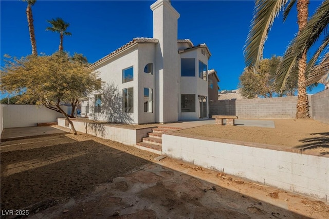 rear view of house featuring a patio