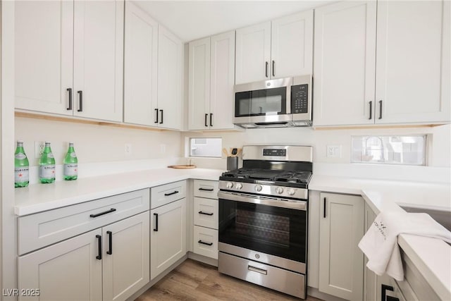 kitchen featuring light hardwood / wood-style flooring, stainless steel appliances, and white cabinetry