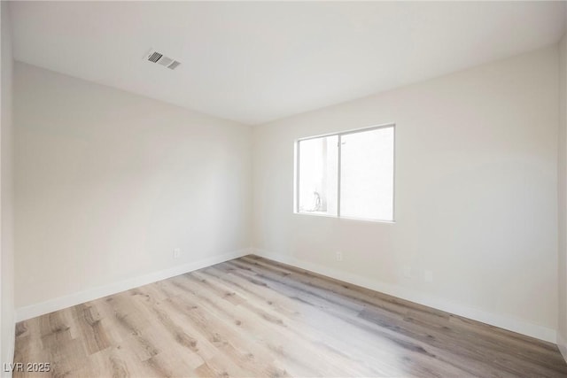 spare room featuring light hardwood / wood-style flooring