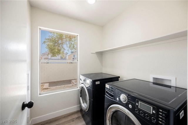 washroom with washer and dryer and light hardwood / wood-style floors