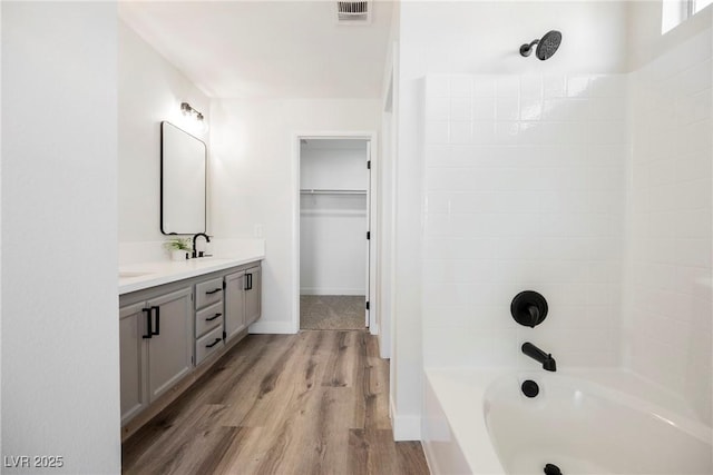 bathroom with shower / tub combination, vanity, and wood-type flooring