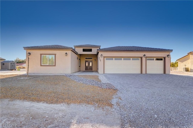 view of front facade featuring a garage, decorative driveway, and stucco siding