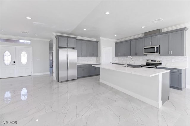 kitchen featuring gray cabinetry, stainless steel appliances, a sink, marble finish floor, and ornamental molding