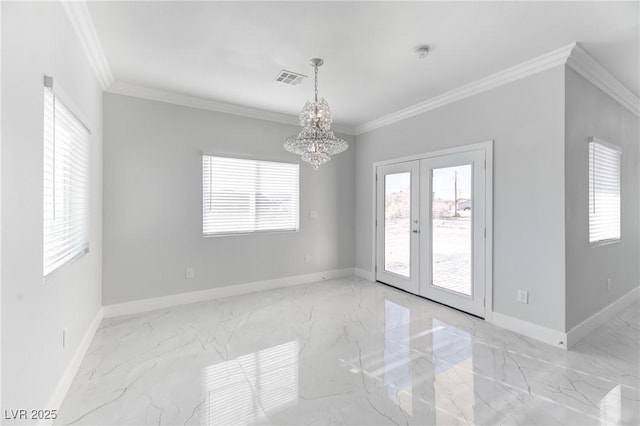 empty room featuring an inviting chandelier, french doors, and crown molding