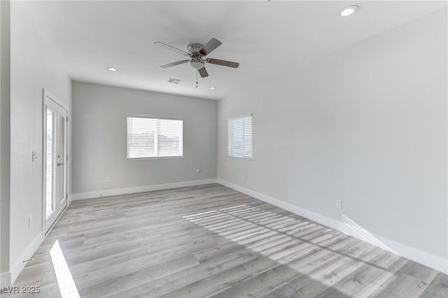 empty room with baseboards, recessed lighting, visible vents, and light wood-style floors