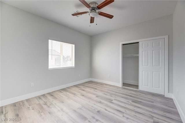 unfurnished bedroom with a ceiling fan, light wood-type flooring, a closet, and baseboards