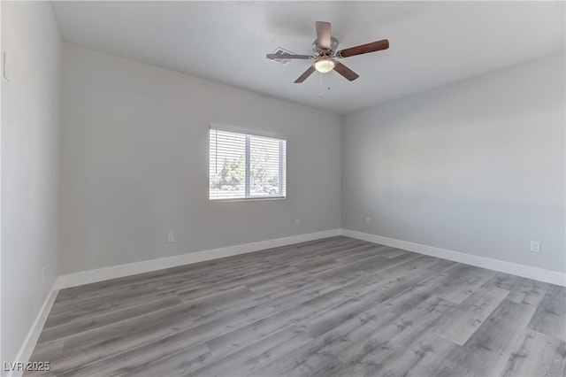 unfurnished room with light wood-type flooring and ceiling fan