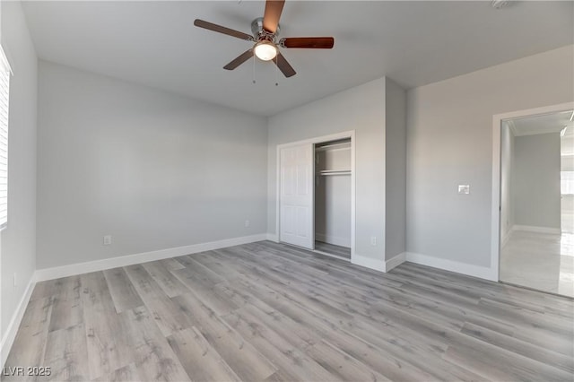 unfurnished bedroom featuring ceiling fan, light hardwood / wood-style floors, and a closet