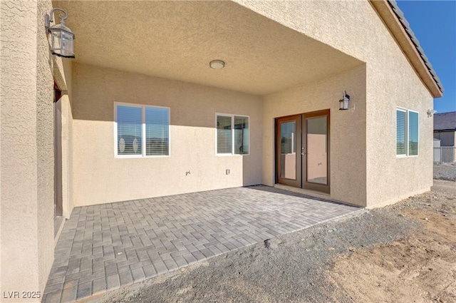 rear view of house featuring a patio and stucco siding