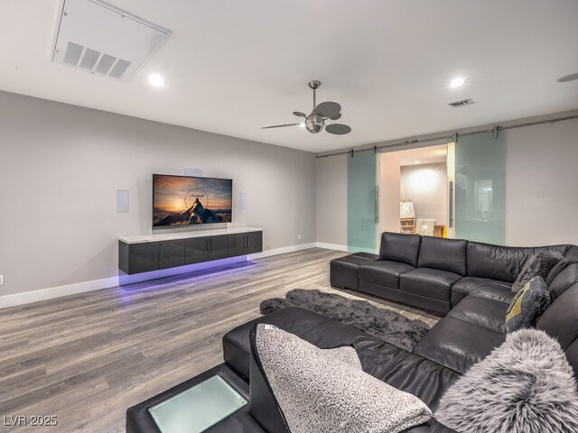 living room with ceiling fan and hardwood / wood-style flooring