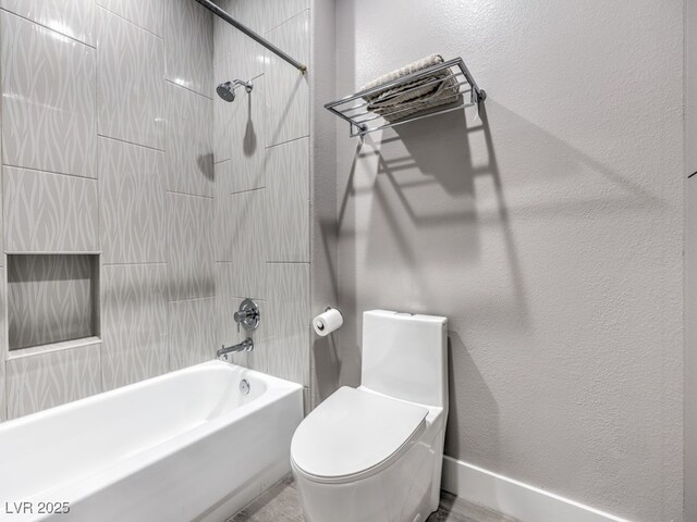 bathroom featuring toilet and bathtub / shower combination