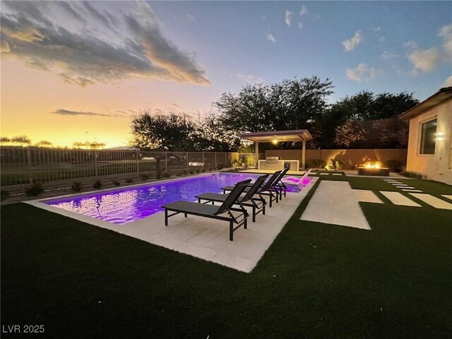 pool at dusk with a patio area