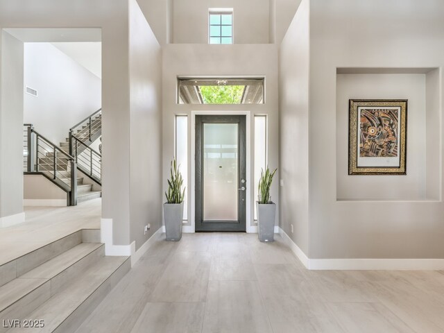 entryway featuring a towering ceiling