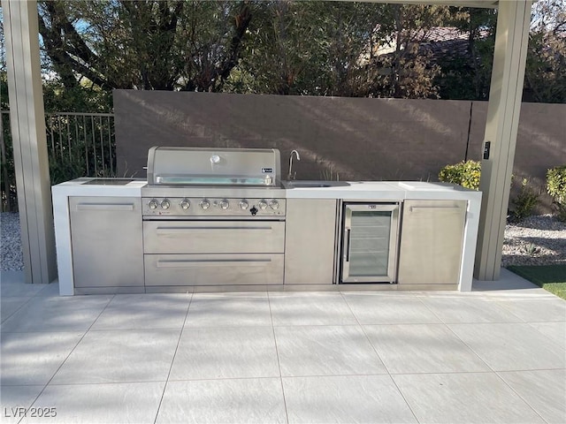 view of patio / terrace featuring sink, an outdoor kitchen, and area for grilling