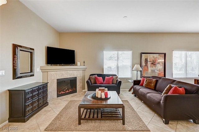 living room featuring light tile patterned floors, a fireplace, and plenty of natural light