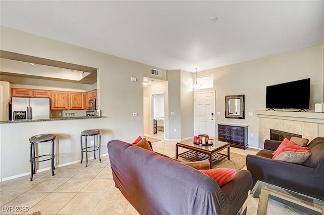 living room featuring a fireplace and light tile patterned floors