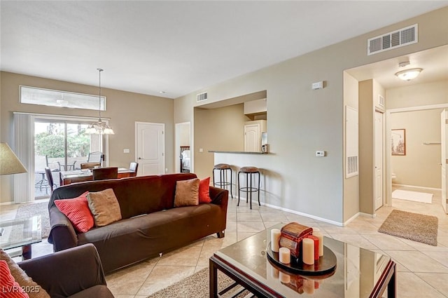 living room featuring an inviting chandelier and light tile patterned floors