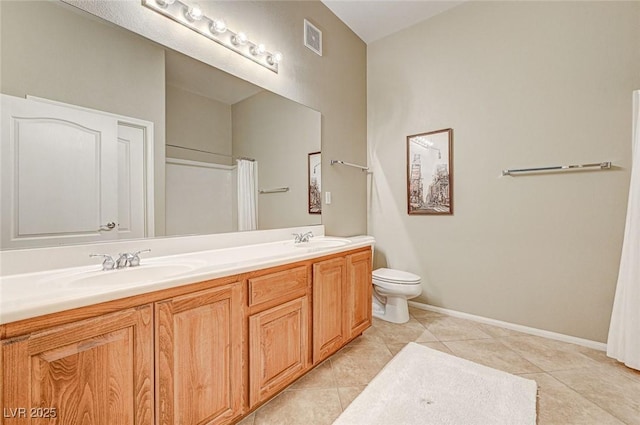 bathroom featuring toilet, vanity, and tile patterned floors